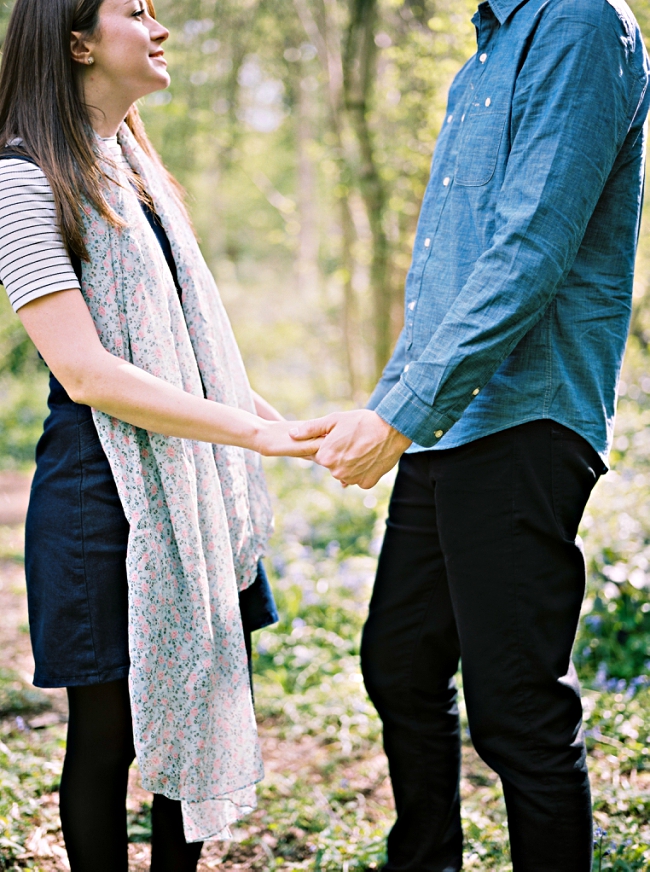 couple holding hands on a pre wedding shoot in swithland wood
