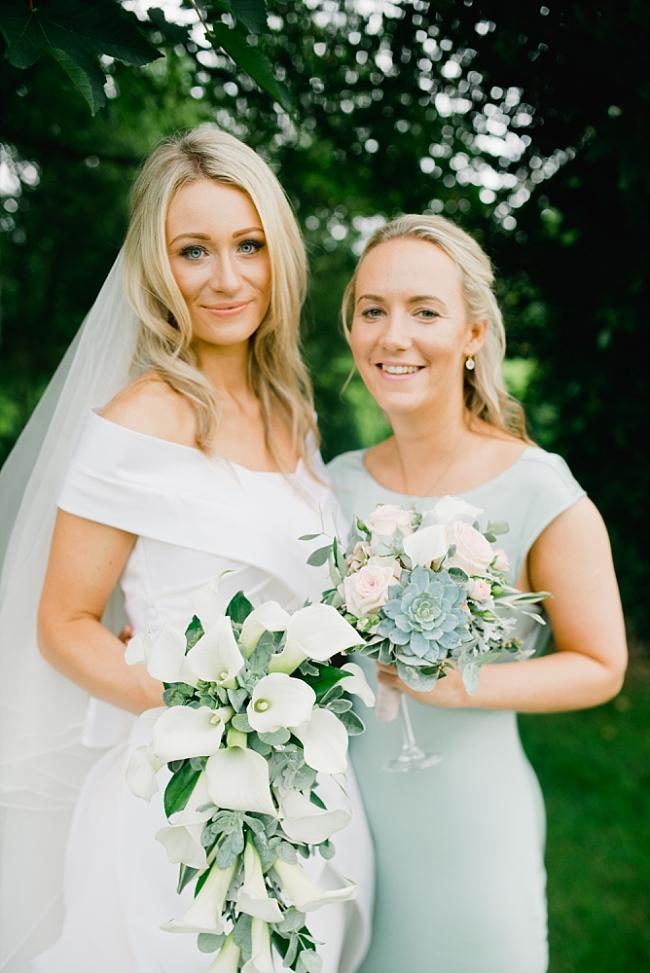 Bride and bridesmaid in green