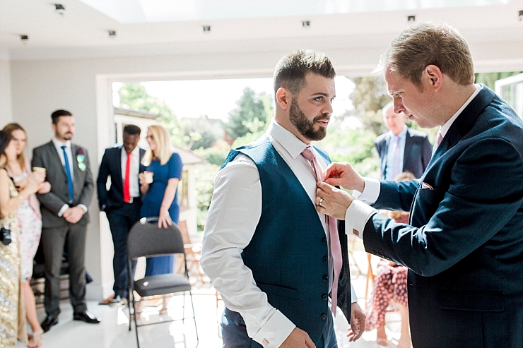 best man ties groom's tie