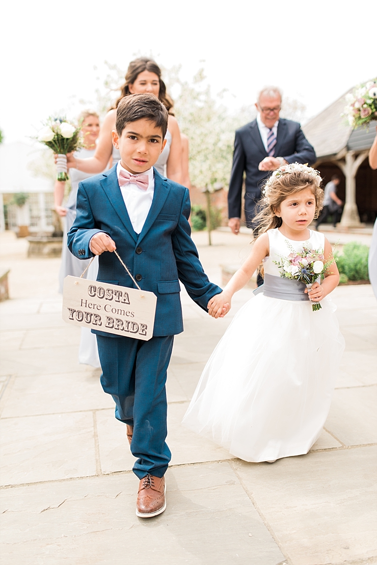 page boy and flower girl with sign