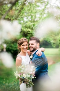 bride and groom through blossom trees