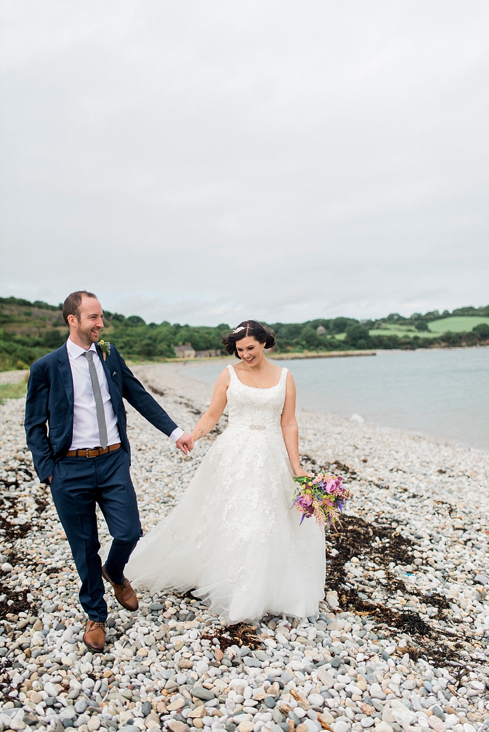 bride and groom on beach anglesey