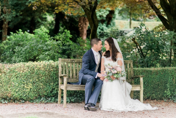 bride and groom on bench