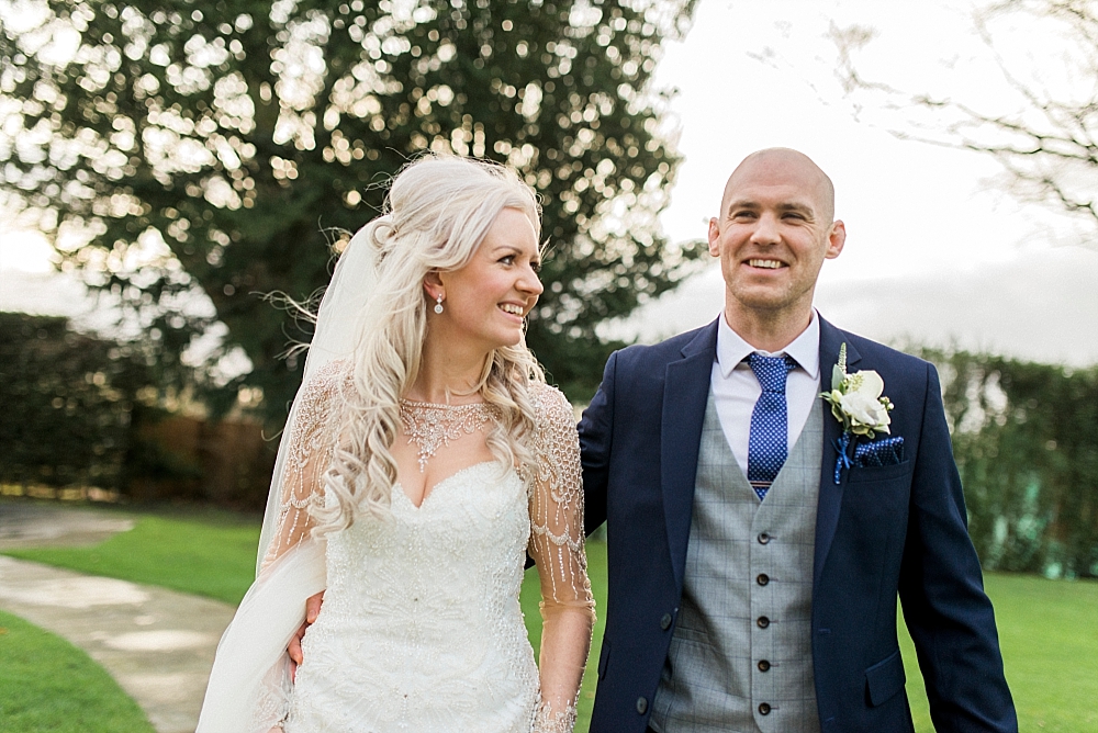 bride and groom smiling in the garden at west tower wedding venue