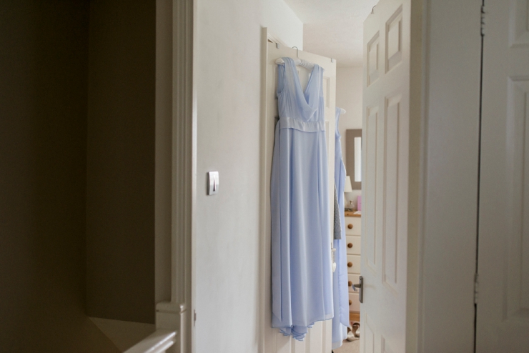 pale blue bridesmaid dress hanging on wardrobe