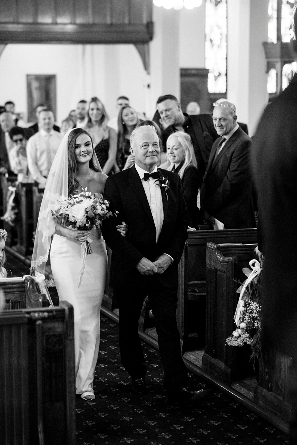 bride and her dad walk down the aisle