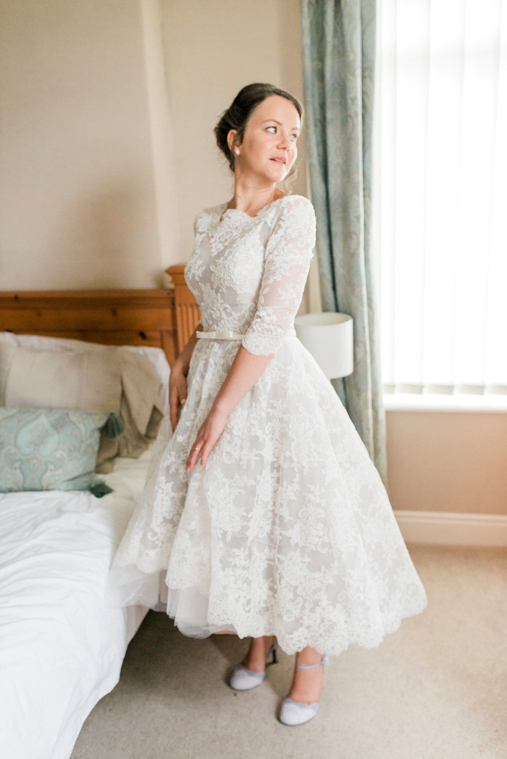 bride in tea length lace dress