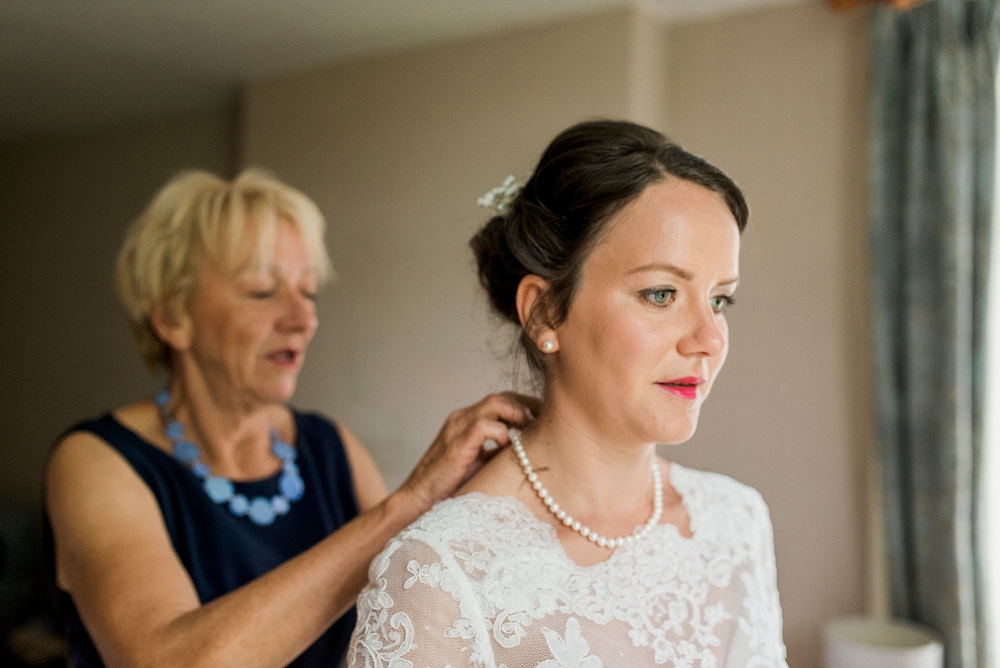 mum fastens brides pearl necklace