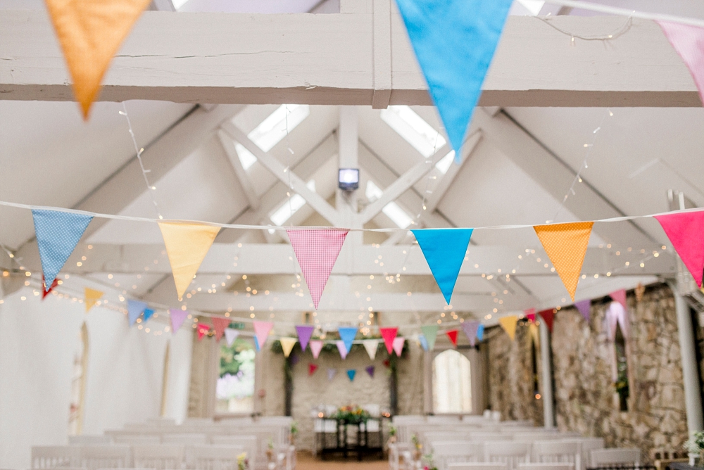 colourful bunting in wedding barn wyresdale park