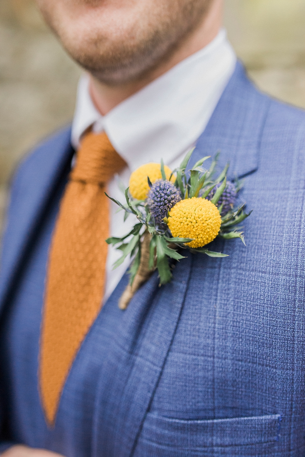 groom's yellow button hole by fylde flowers