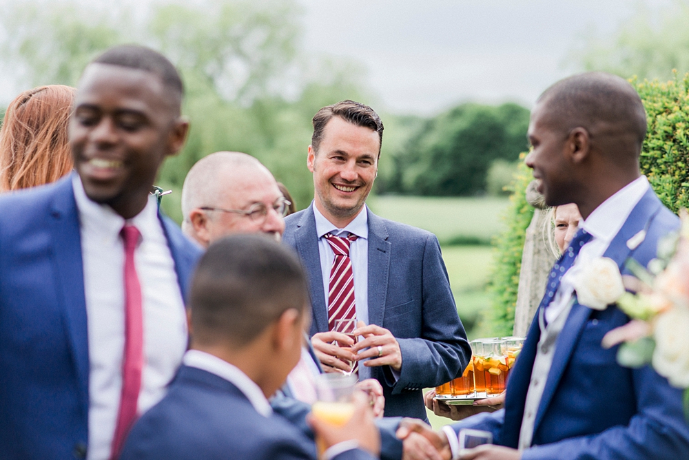 wedding guests having drinks on lawn