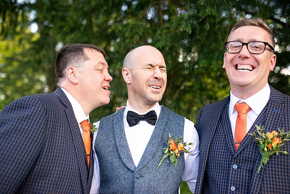 silly groomsmen pulling faces