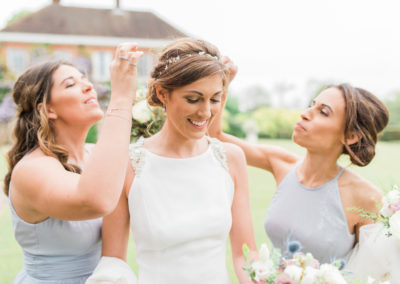 bridemaids pick confetti from bride's hair