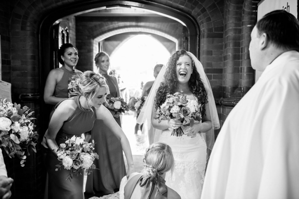 bride laughing as she arrives at st Josephs church birkenhead