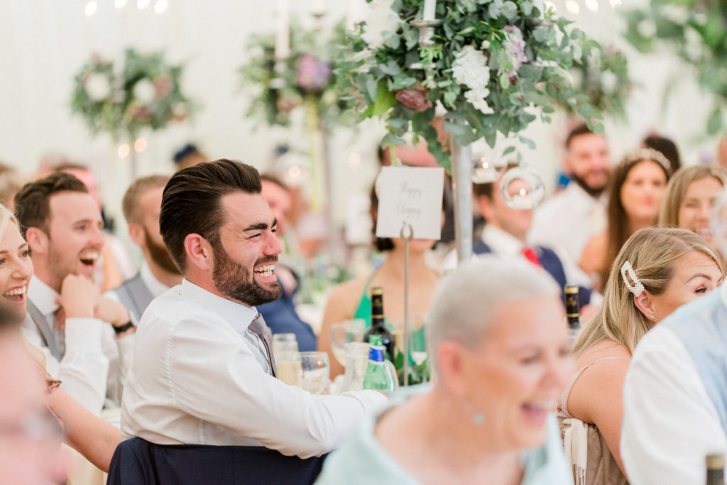 guest laughing at wedding speeches