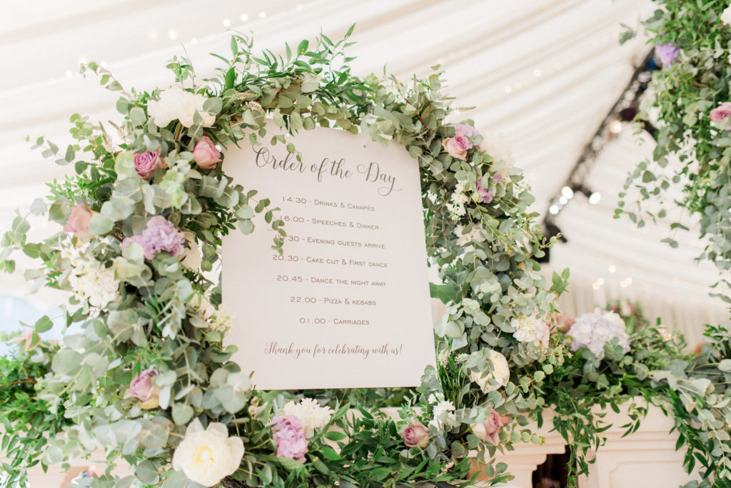 order of the day sign with flower frame