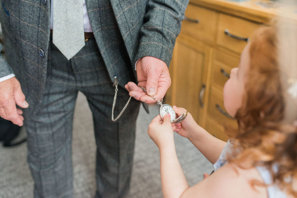 flower girl looking at pocket watch