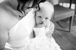 bride cuddling baby as he sheds a tear