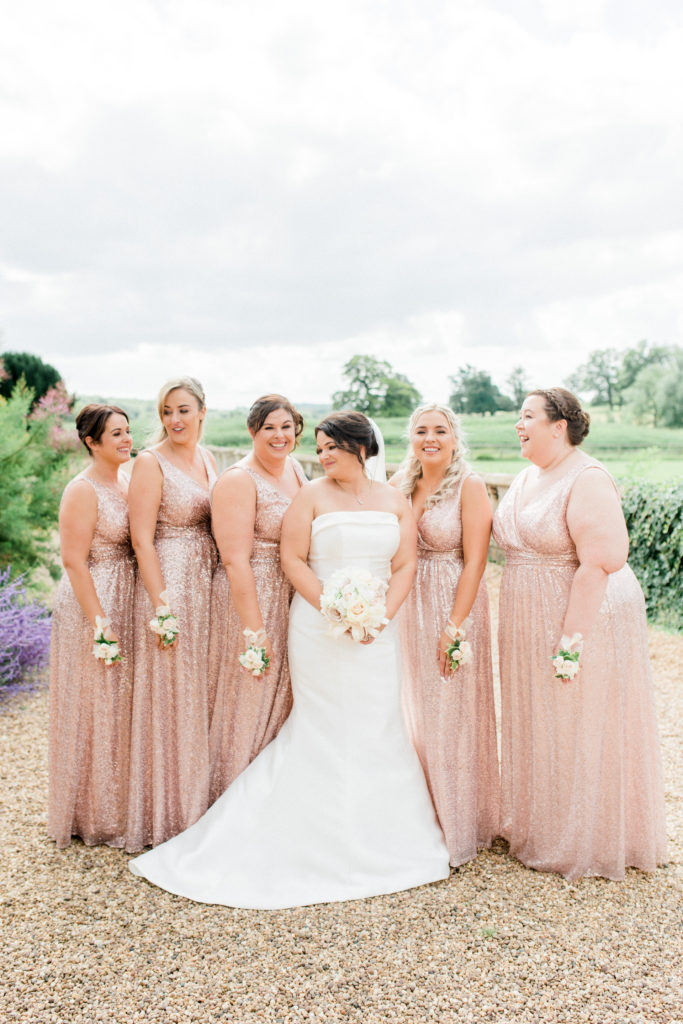 bride and bridesmaids wearing sparkly pink at Walton hall wedding