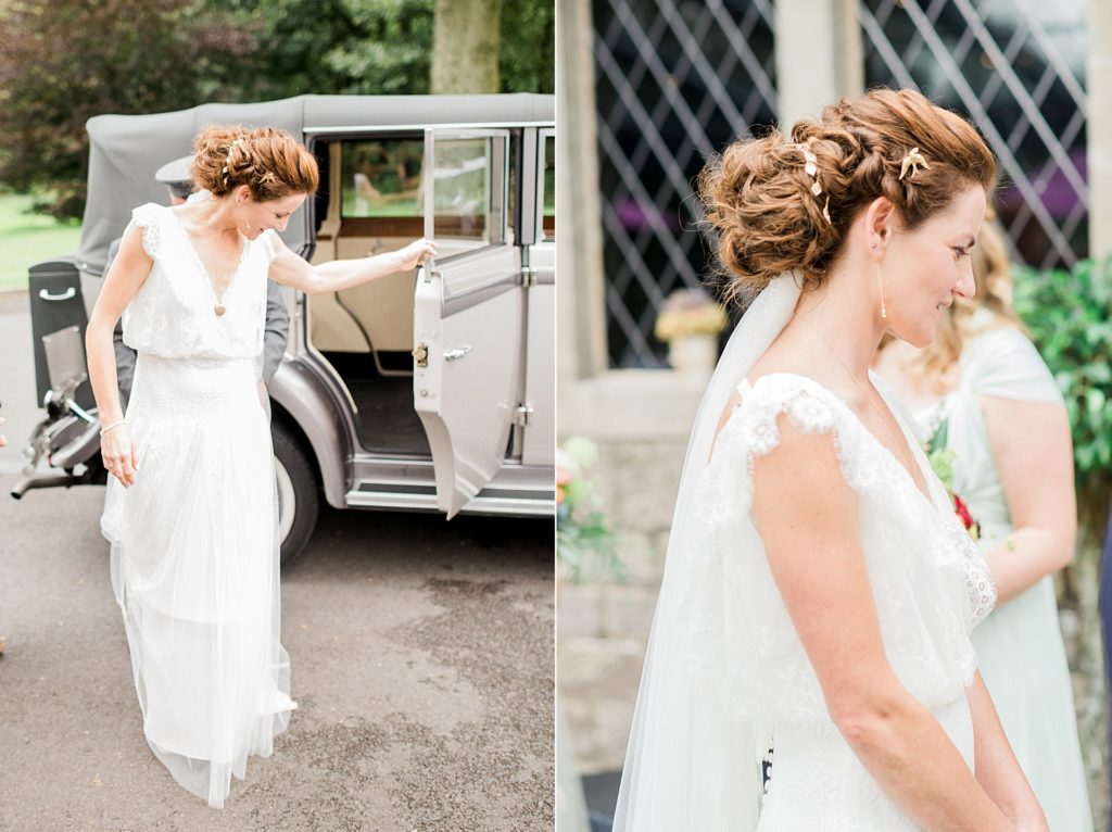 bride with auburn hair steps out of wedding car at rivington barn