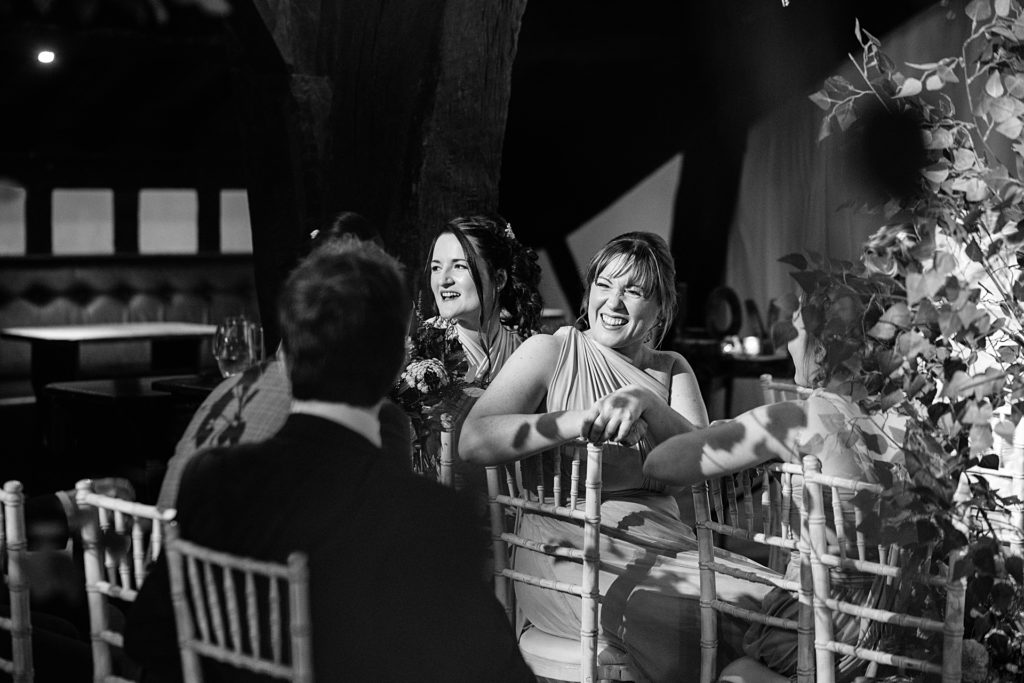 bridesmaid laughing during wedding ceremony