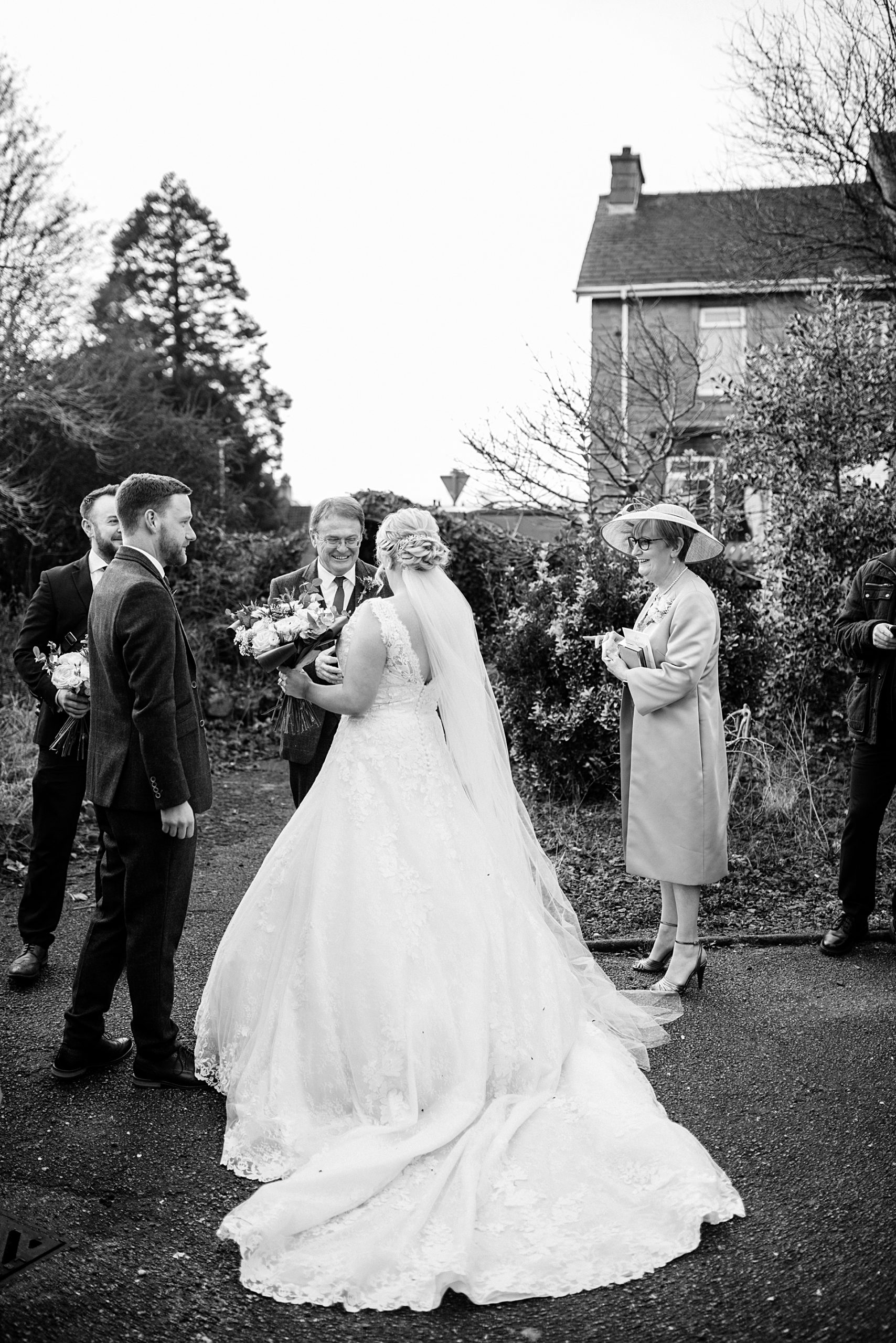 black and white photo of bride outside church