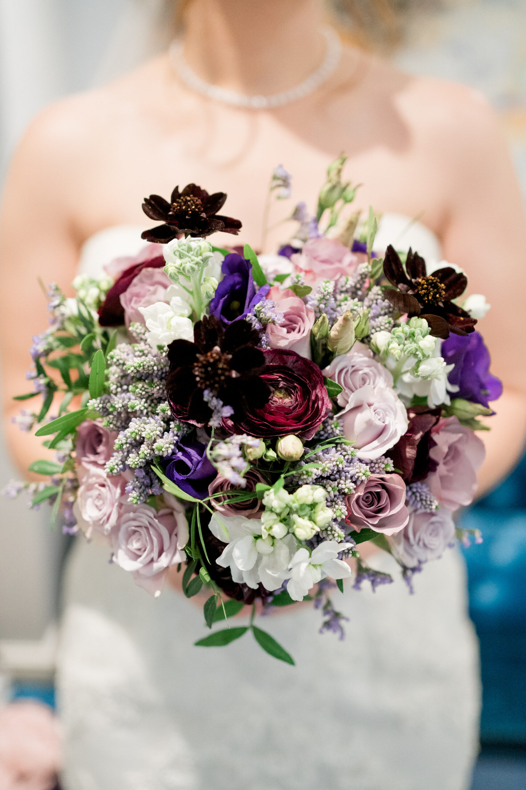 purple wedding bouquet by river and rose