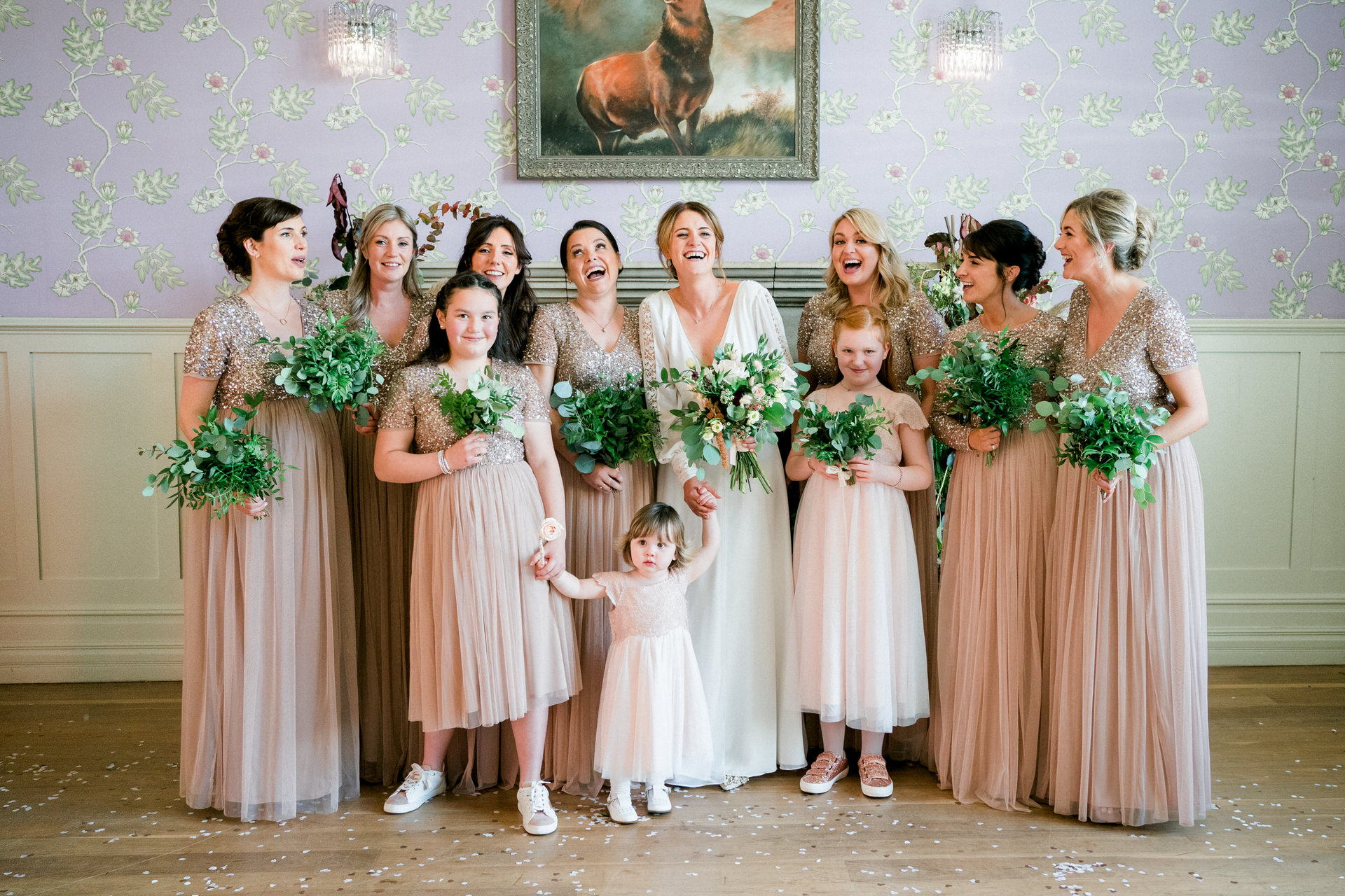 bride and bridesmaids in front of fireplace at the swan hotel newby bridge