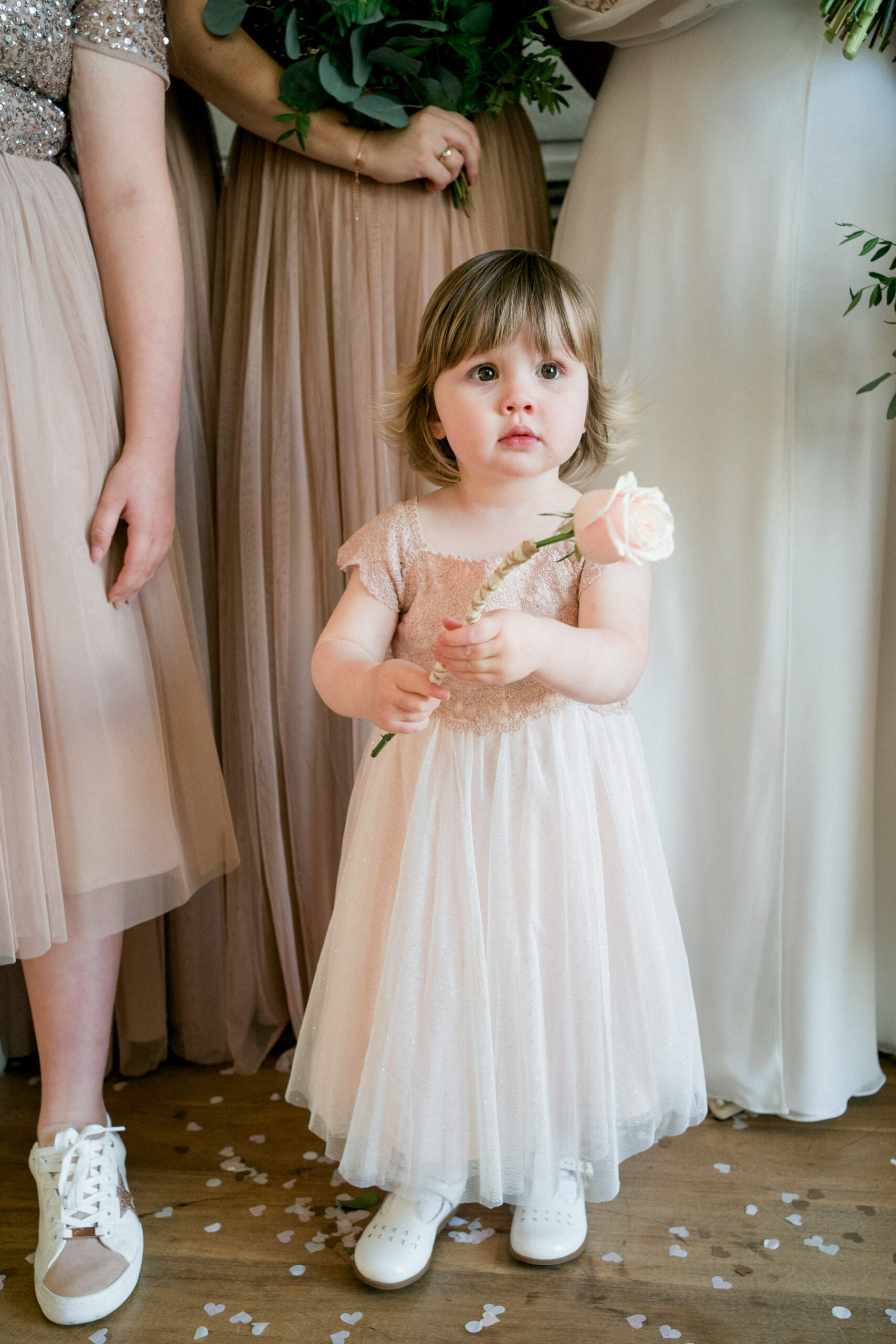 flower girl in pale pink with single rose