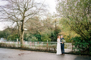 bride and groom at swan hotel newby bridge wedding with flooded river