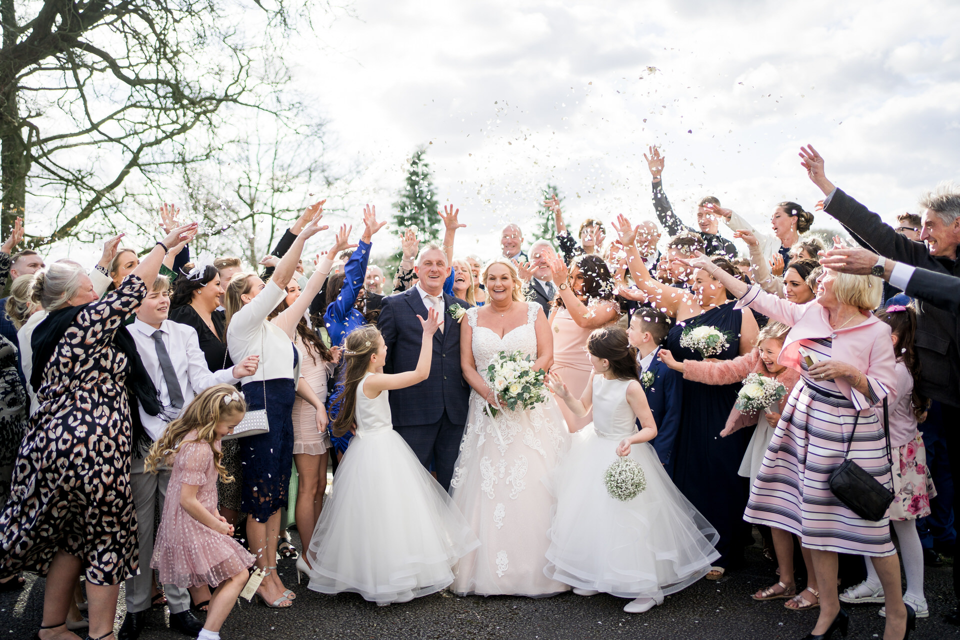 guests throw confetti over bride and groom a shaw hill