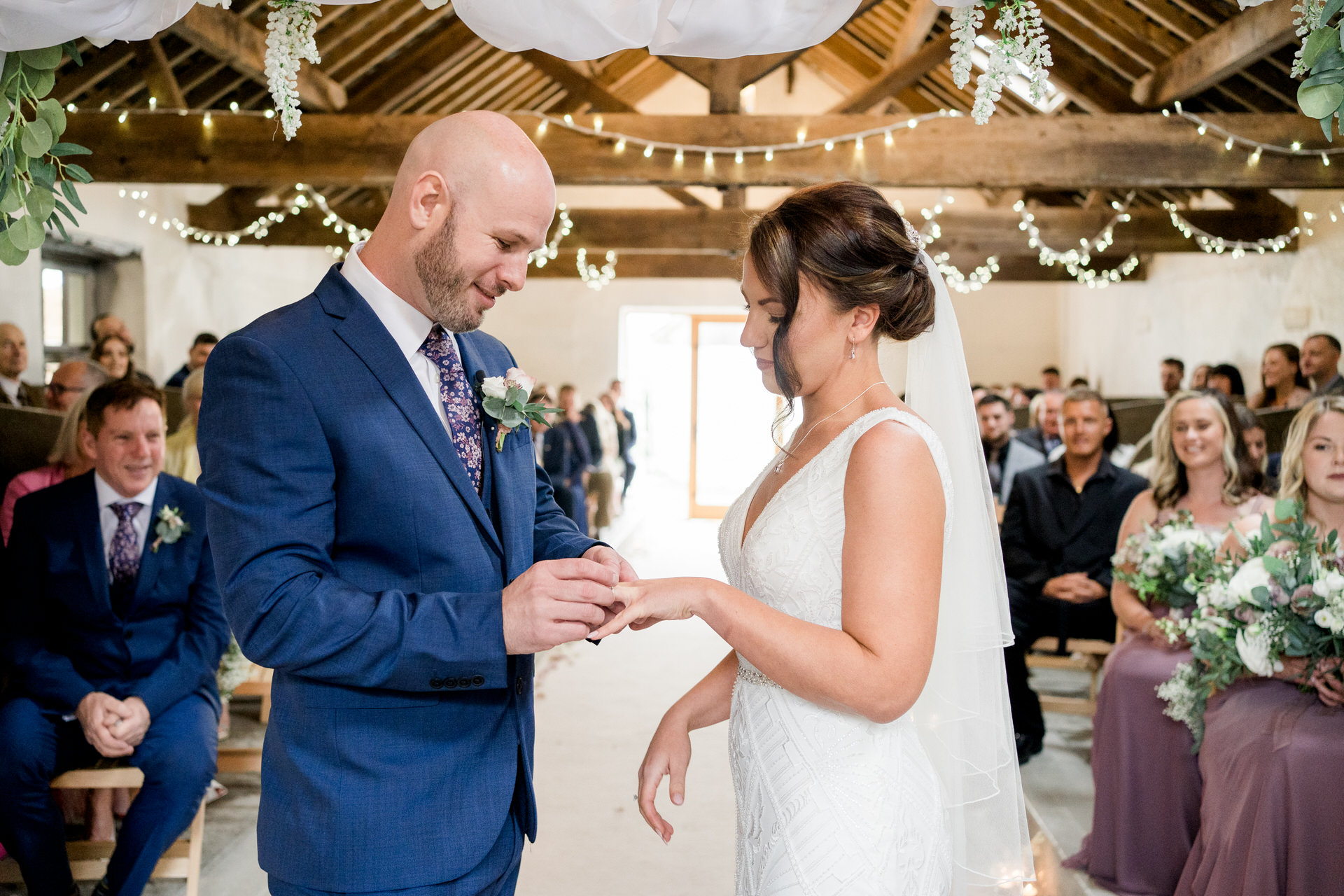 exchanging rings in Fairbanks wedding barn ceremony