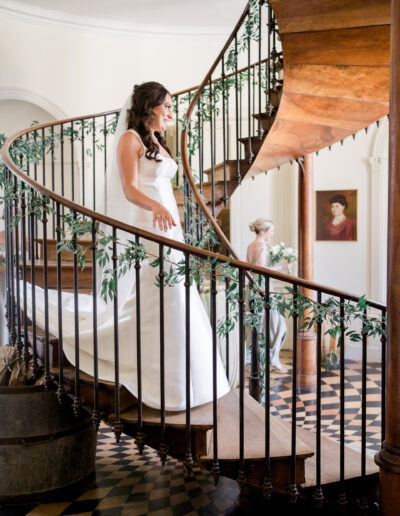 bride coming down spiral staircase at chateau de brives