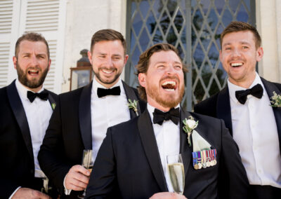groomsmen laughing at chateau de brives wedding