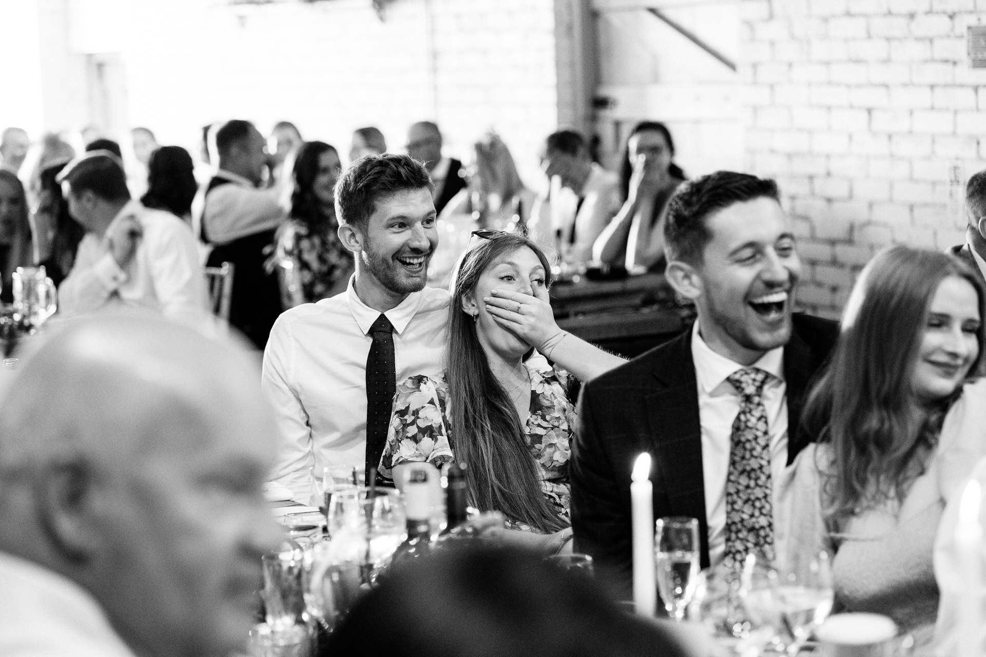 guests react to speeches at eden barn wedding