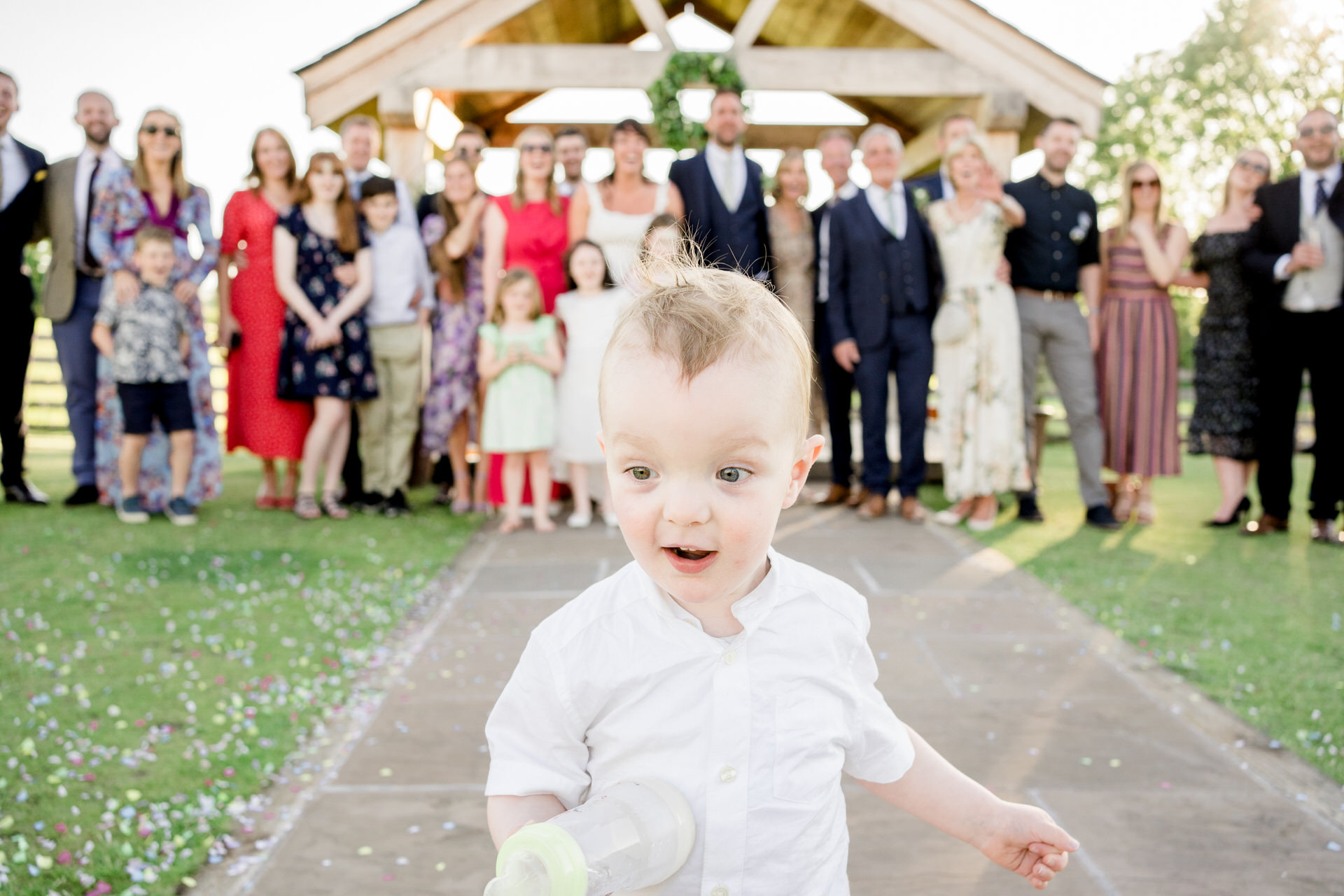 little boy photo bombs group wedding photo