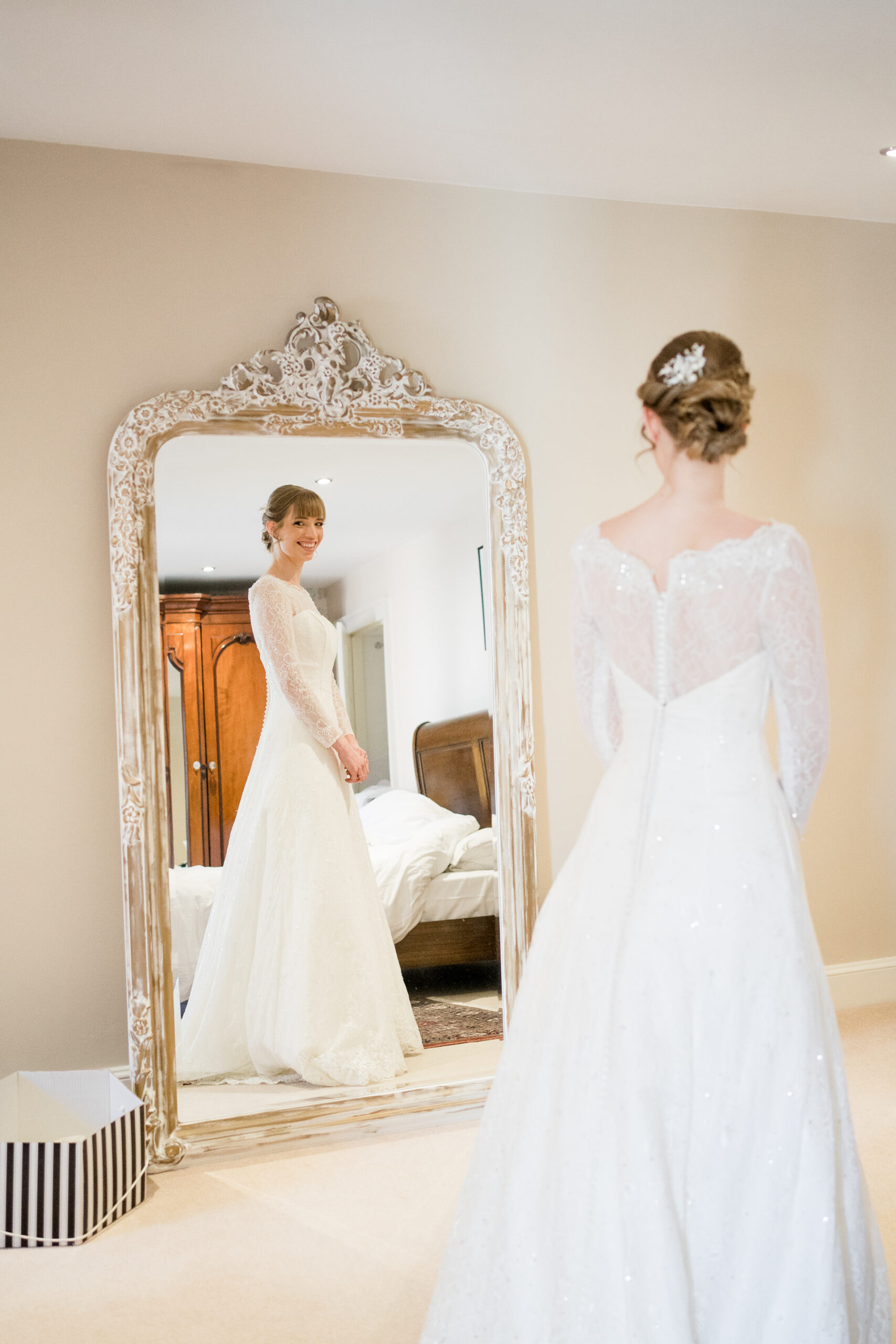 bride standing in front of full length mirror