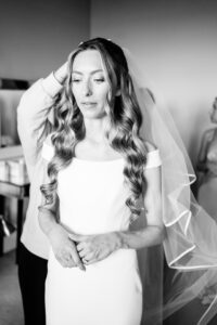 black and white photograph of bride with mermaid curls by wedlocks hair