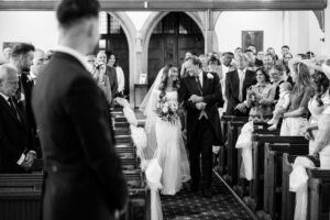 bride walks down the aisle with her father at st cuthberts church in lytham