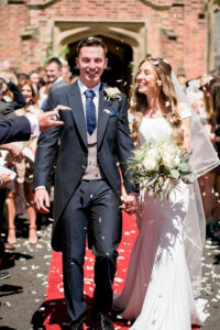 bride and groom with guests throwing confetti at st cuthberts church in lytham