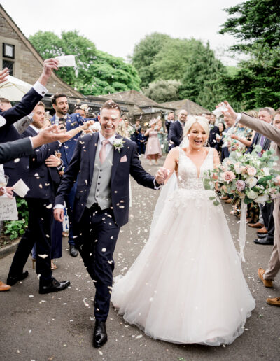 bride and groom in confetti tunnel at elegant Rivington Barn wedding