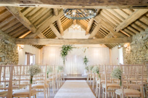 Hyde Bank Farm wedding ceremony room set up with drapes and flowers
