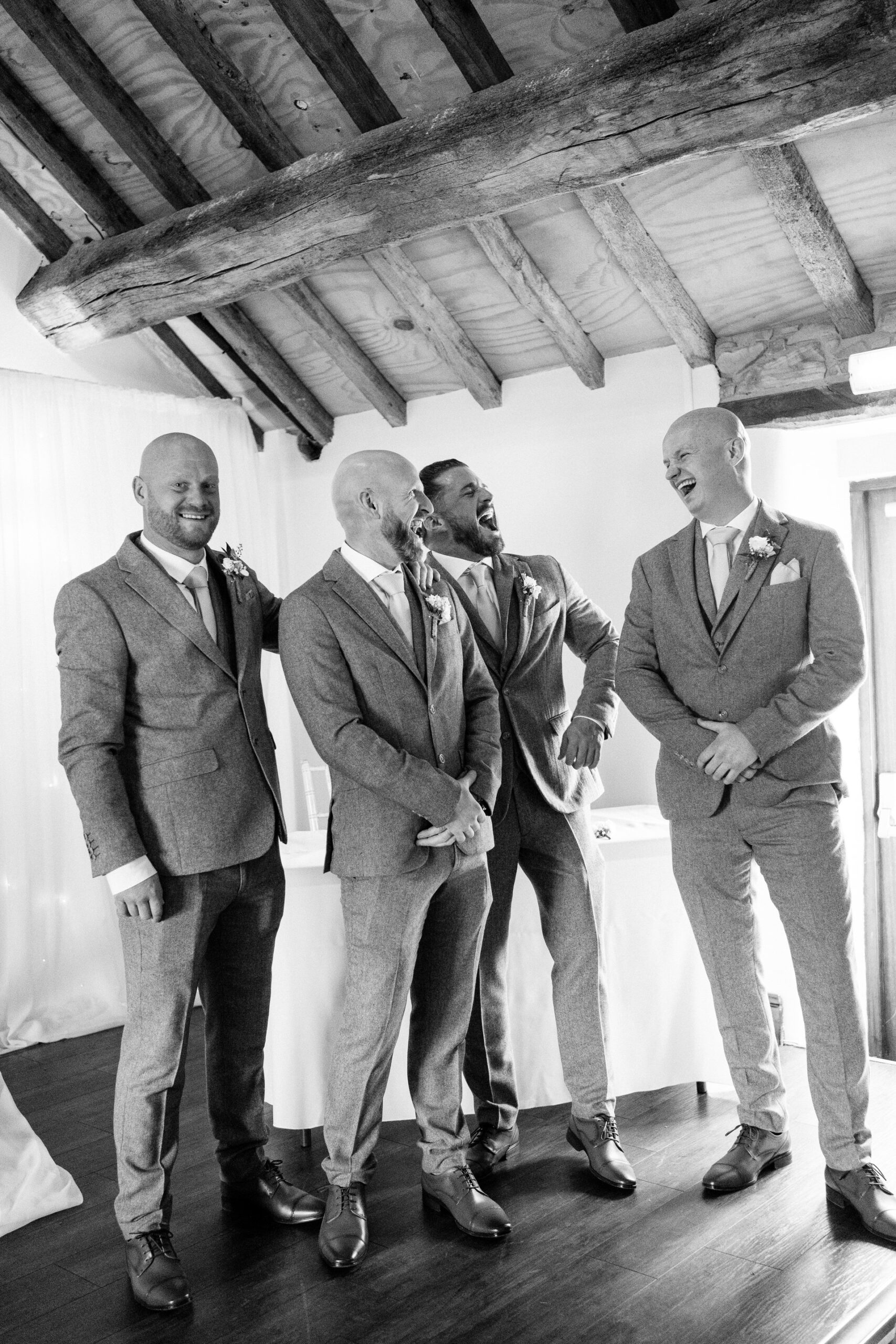 groom and groomsmen laughing just before wedding ceremony
