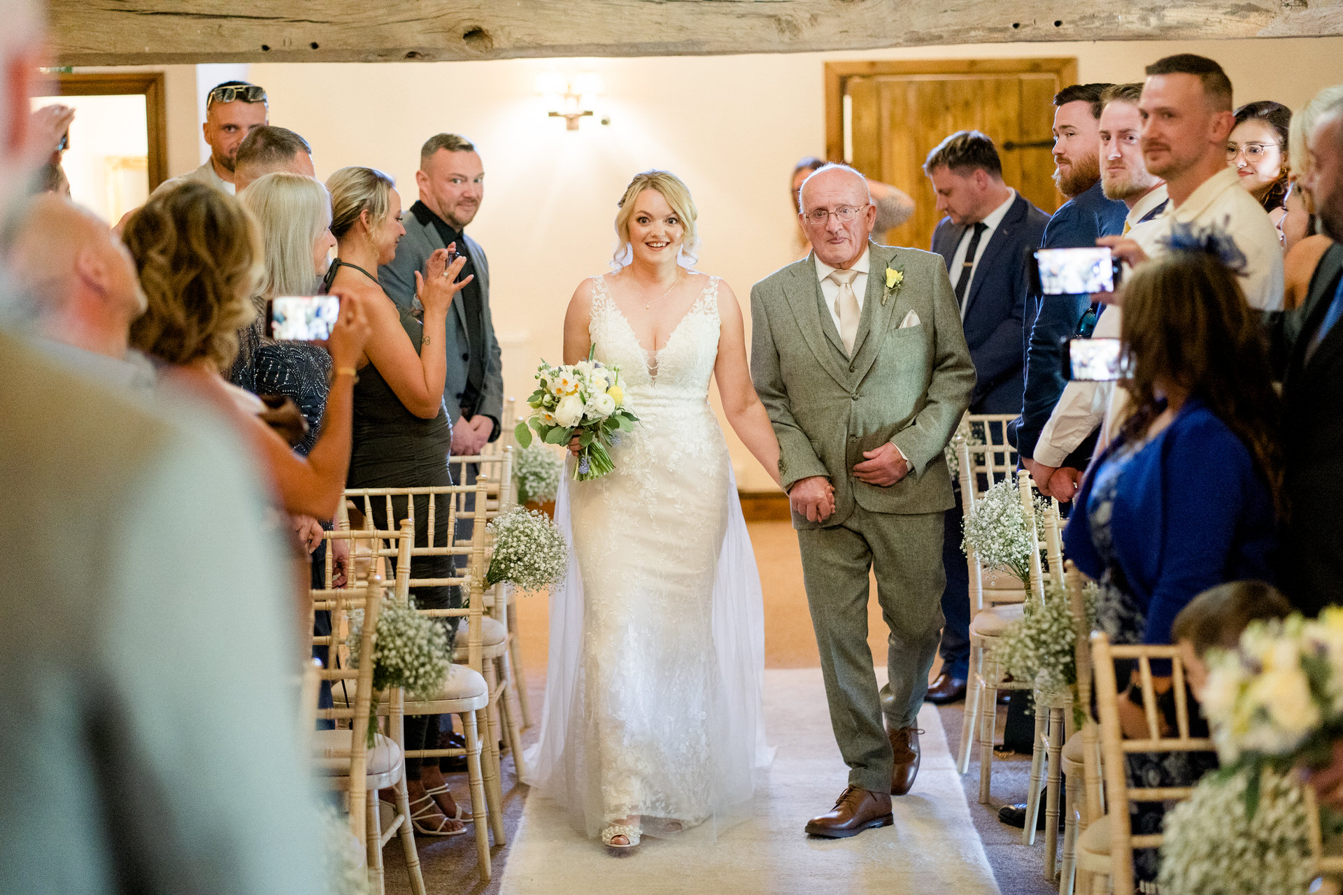 bride walks down aisle with grandad at Hyde bank farm wedding ceremony