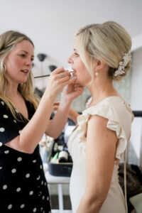 Sarah Morton make=up artist applies lipstick to bride at didsbury house