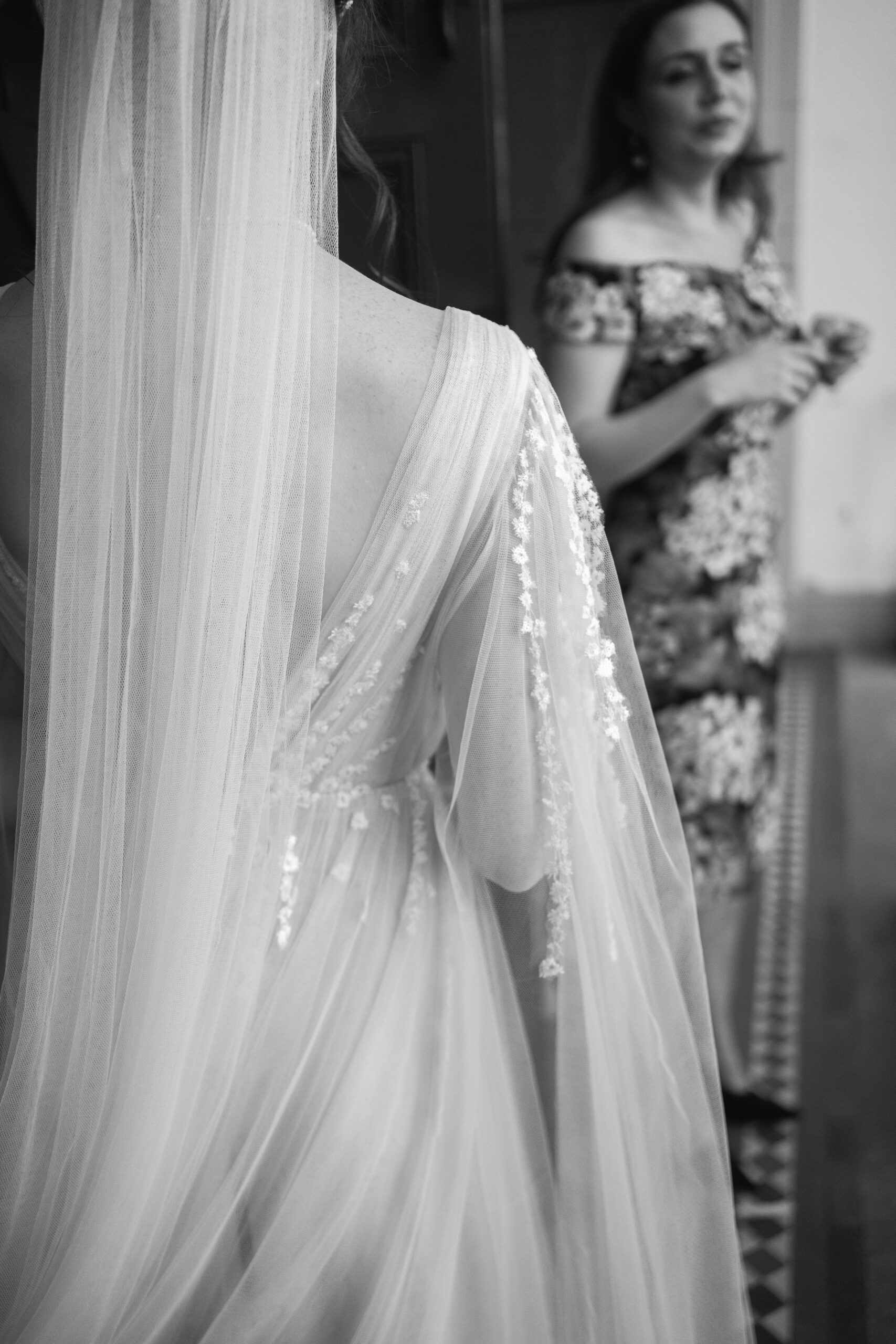black and white close up detail photograph of a bride wearing an Anna kara dress with sheer sleeves