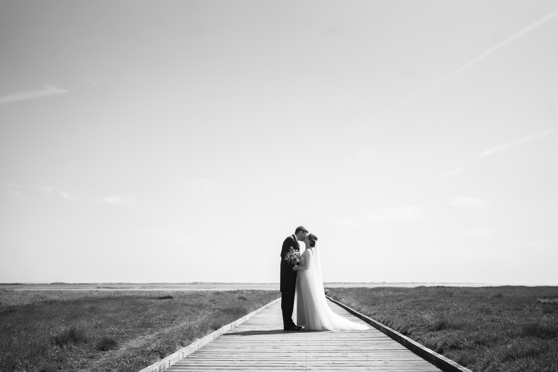 bride and groom kissing on the jetty at lytham st annes