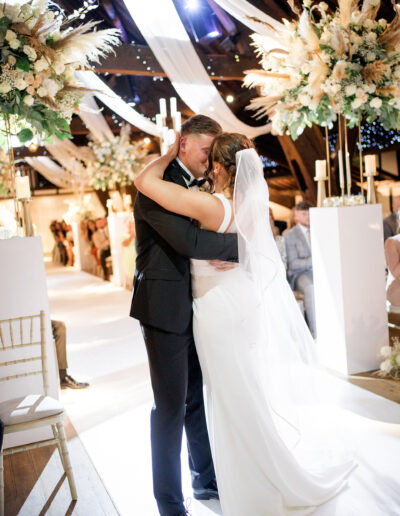 bride and groom first kiss at Rivington hall barn wedding