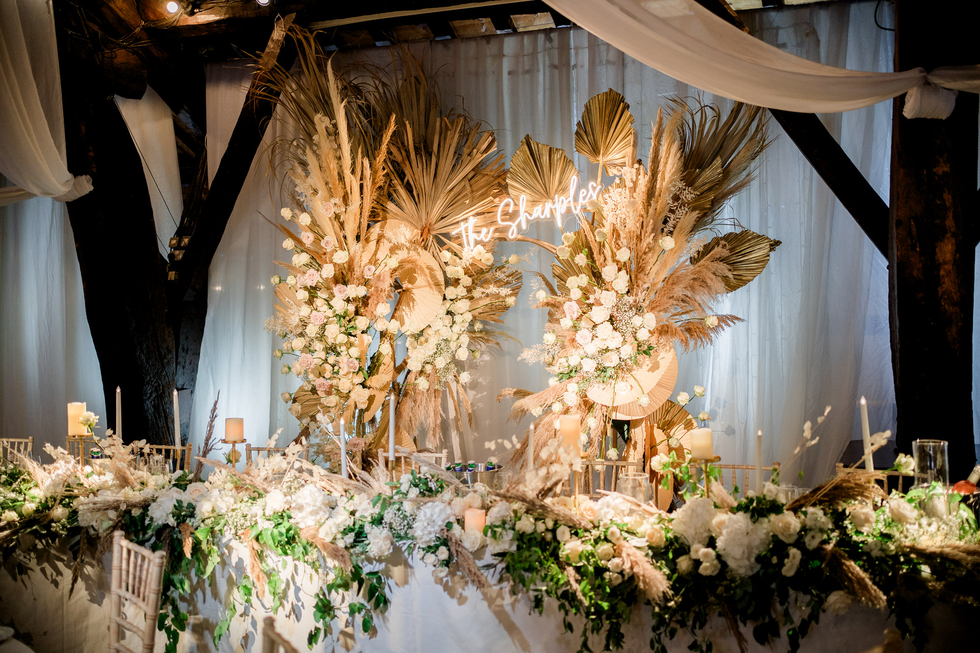 flower arch by red floral at Rivington hall barn, with pampas and neon sign