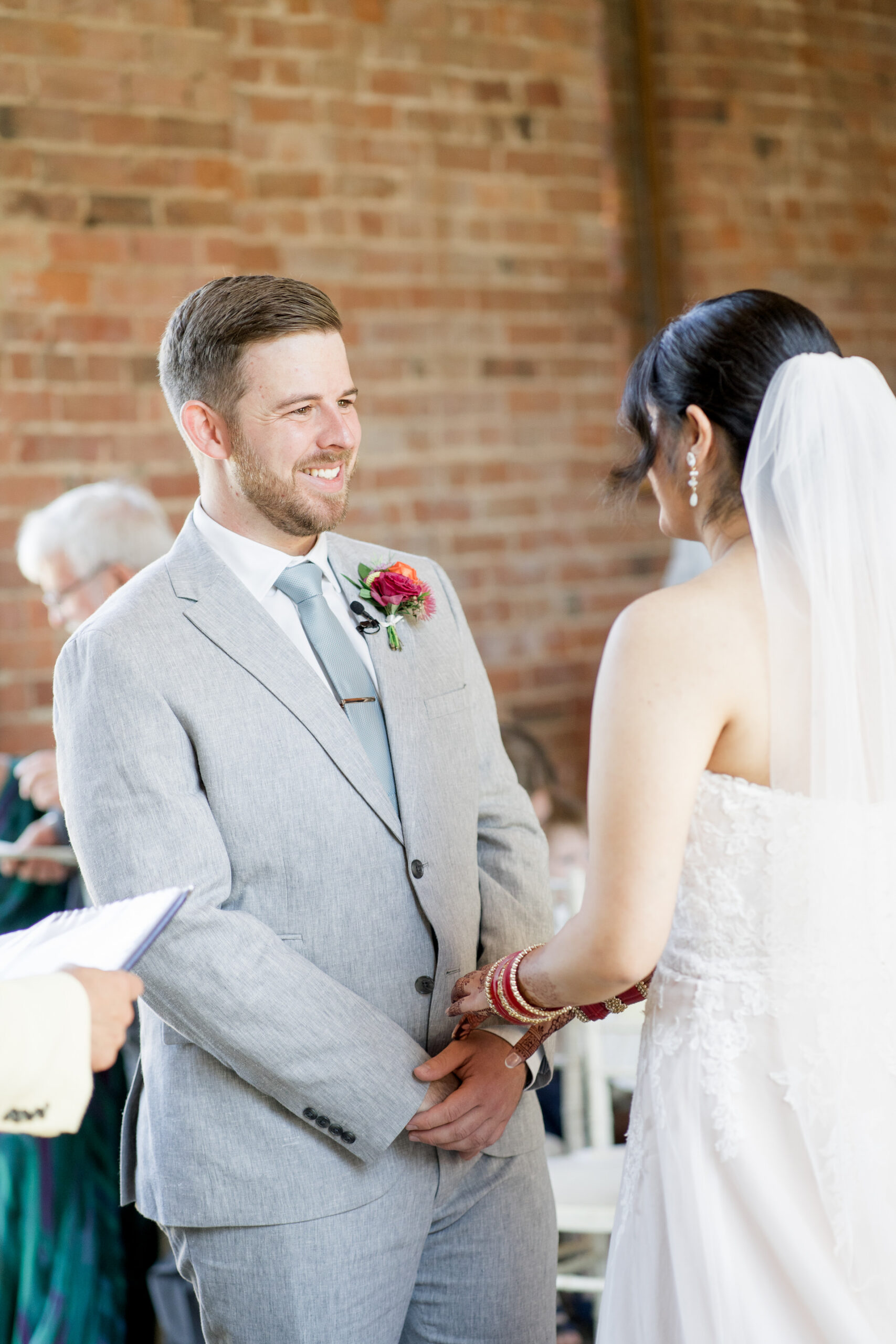 bride and groom exchange vows at mickleton hills farm wedding 